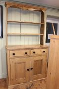 Waxed pine dresser having open shelf back above two drawers with two cupboard doors below,
