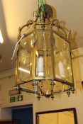 Large brass and glass octagonal hall lantern with later electrical fitting.