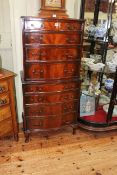 Mahogany serpentine eight drawer tallboy chest, 139cm by 62cm by 45cm.