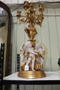 Ornate gilt cherub candelabra, 80cm high.