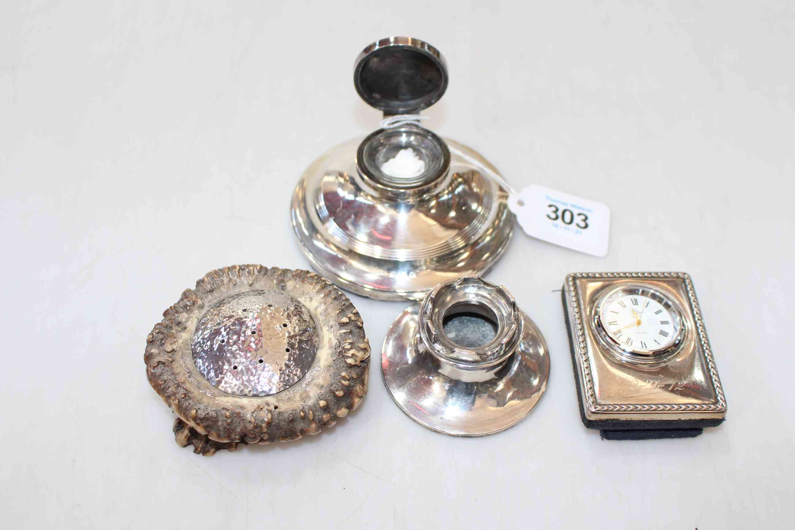 Four silver pieces comprising Capstan inkwell, pen stand, boudoir clock and hat pin stand.