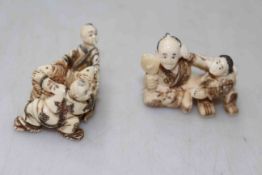 Two antique ivory figure netsuke, one with fishes, each approximately 4cm across.