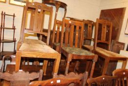 Rectangular oak dining table and fourteen dining chairs including two sets of four.