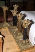 Five brass corinthian column oil lamp bases, 30cm high.