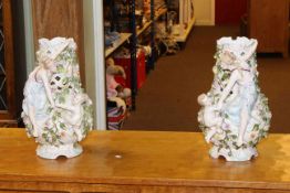 Pair of Continental Cupid and floral encrusted vases, 37cm.