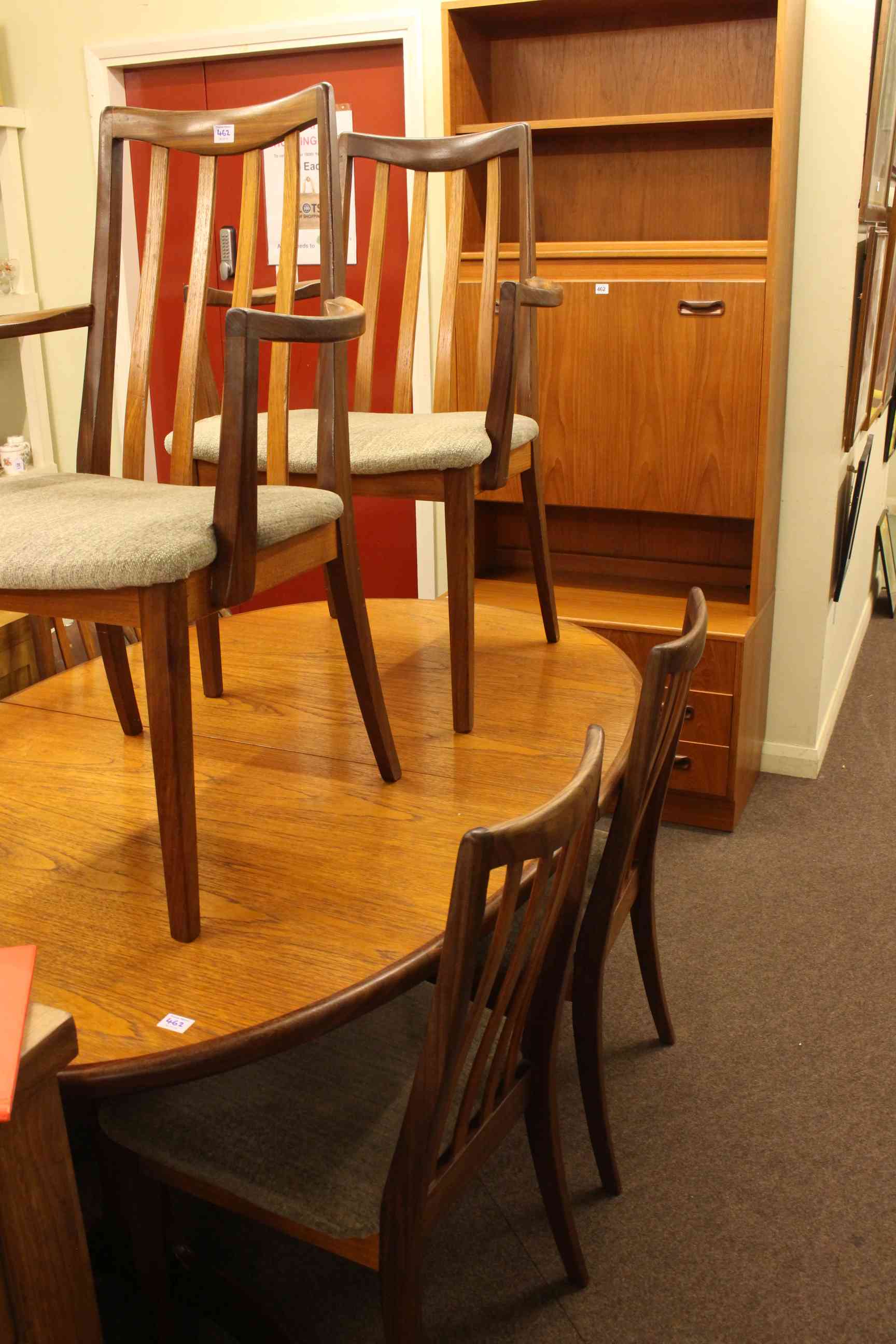 G Plan teak cocktail wall unit, oval extending dining table and six chairs.