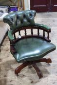 Captains style green leather swivel desk chair.