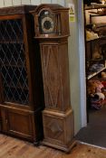 Limed oak grandmother clock having arched brass dial.