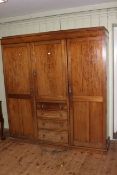 Mahogany combination wardrobe having central door above four drawers,