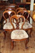 Set of five Victorian mahogany balloon back dining chairs with serpentine front seats.