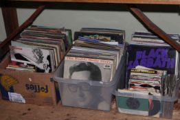 Three boxes of vinyl records and singles.
