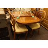 Yew extending dining table and leaf together with four balloon back dining chairs.