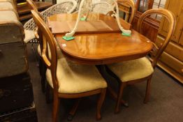 Yew extending dining table and leaf together with four balloon back dining chairs.