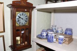 Two Honiton pottery jugs, Ringtons caddies, jugs, plates, oak wall clock, etc.