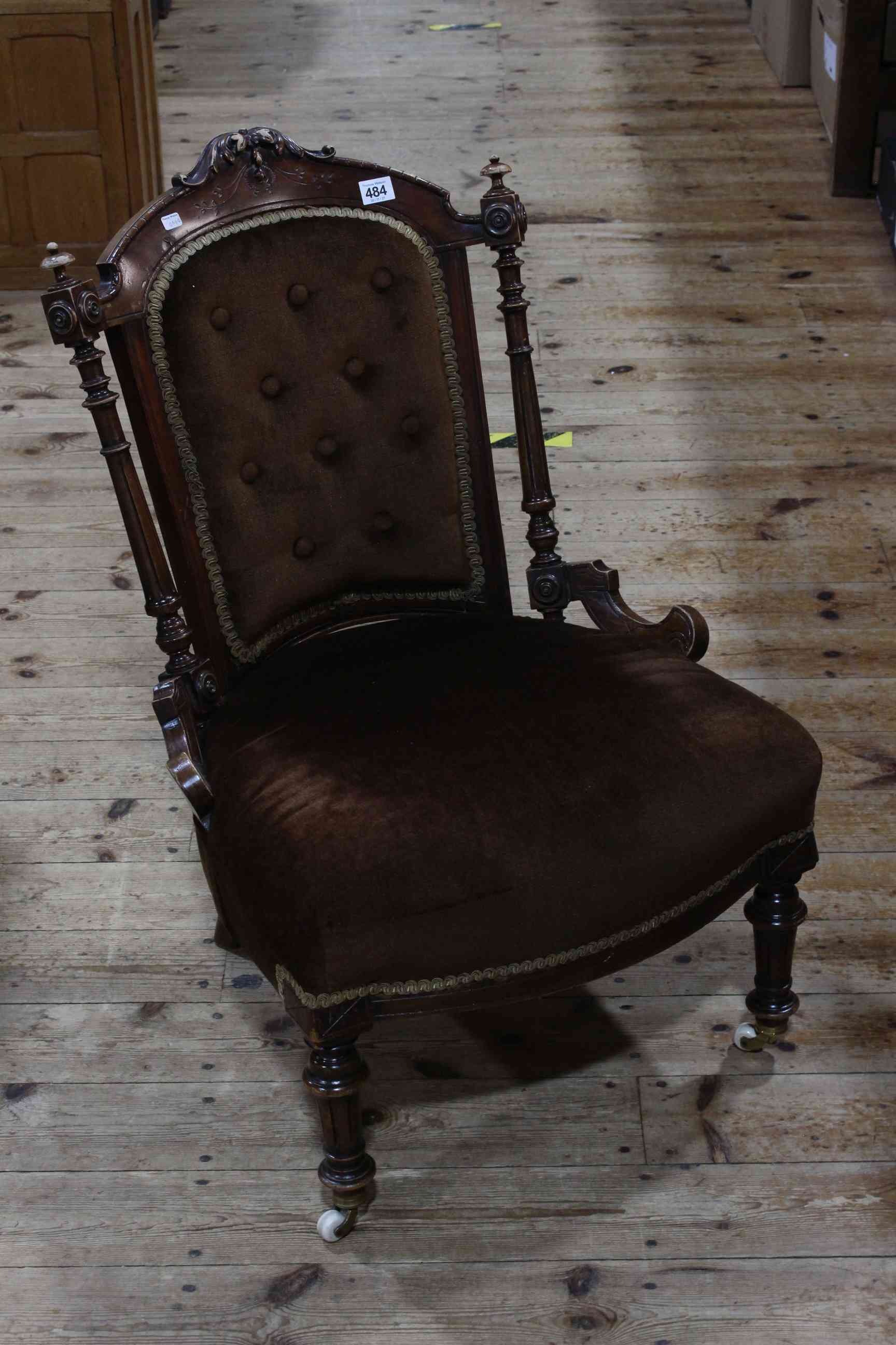 Victorian walnut framed button back nursing chair on turned legs.