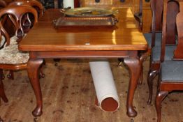 Mahogany extending dining table, leaf and winder, raised on cabriole legs,