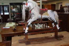 Collinson of Liverpool, dappled rocking horse on safety stand, 102cm x 122cm.