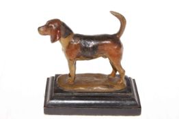 Cold painted metal figure of hound on wood plinth base, 15cm high.