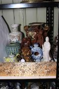 Collection of Oriental porcelain including two handled vase, jar, teapots, carved wood statues,