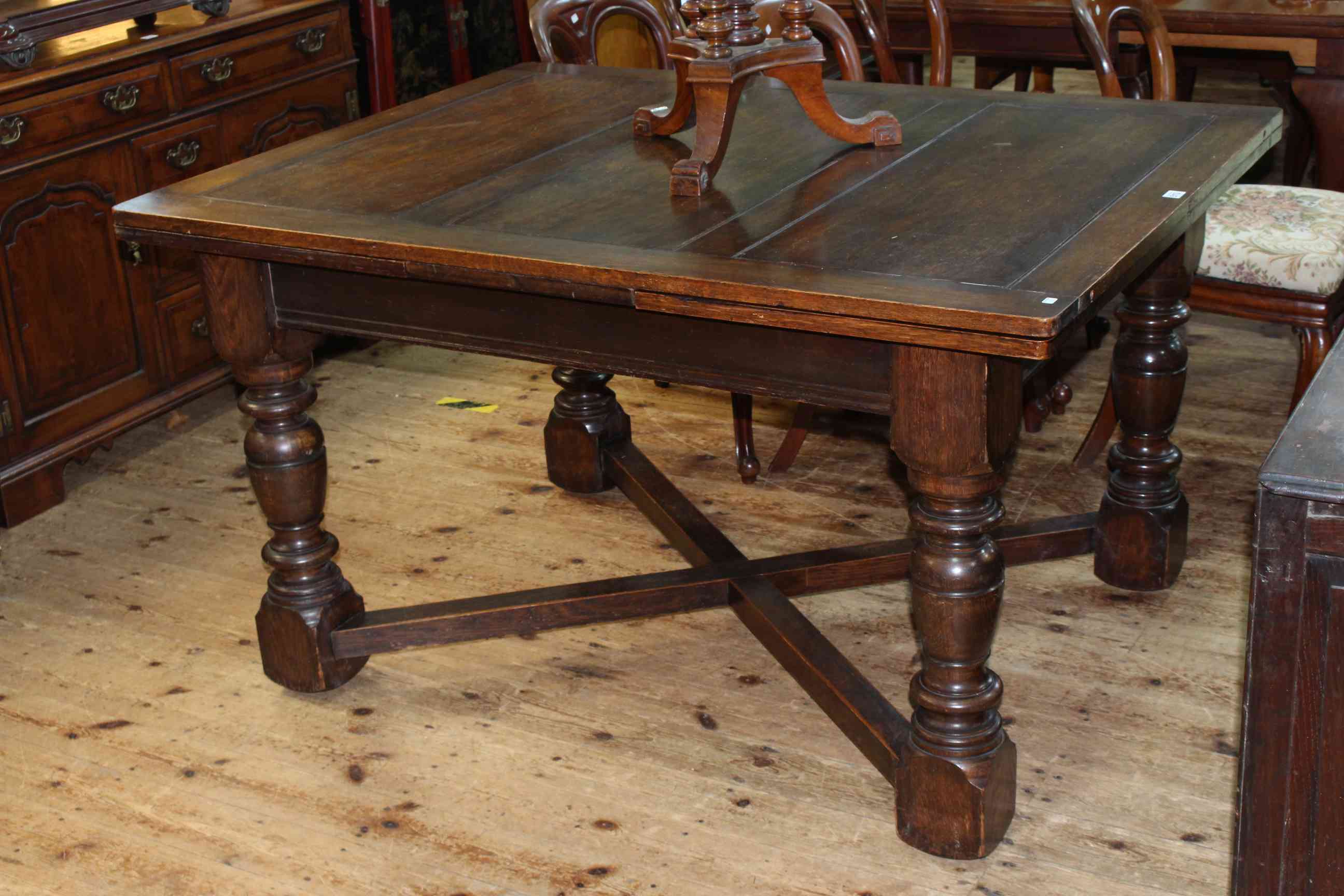 Large oak draw leaf dining table, 78cm x 107cm x 137cm.