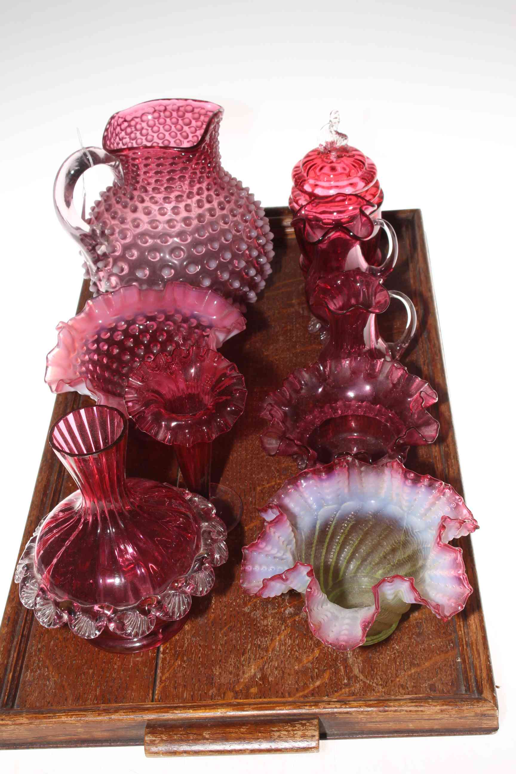 Collection of Victorian ruby glass including jugs, vase, three dishes and preserve.