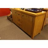 Light oak two door sideboard, 80.5cm x 150cm x 47cm.