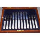 Cased set of six silver and mother of pearl dessert knives and forks,