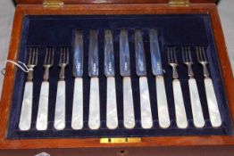 Cased set of six silver and mother of pearl dessert knives and forks,