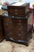 Mahogany serpentine front chest of two short above three long drawers on bracket feet,