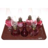 Five Victorian finger oil lamps, small ruby glass oil lamp and vase.