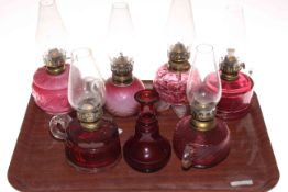 Five Victorian finger oil lamps, small ruby glass oil lamp and vase.