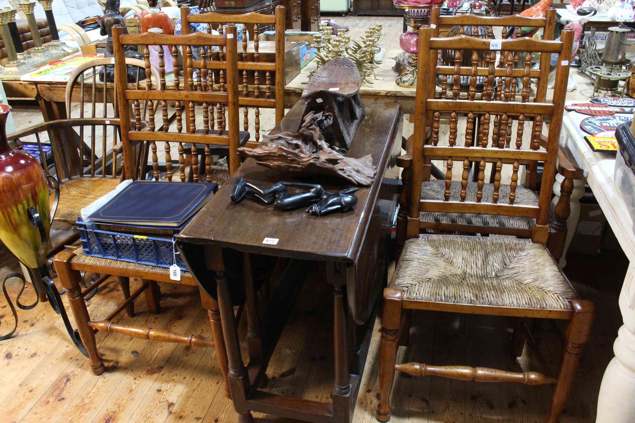 Antique jointed gateleg dining table and four rush seated country dining chairs.