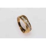 18 carat gold crossover design ring set with row of seven diamonds, size O/P.