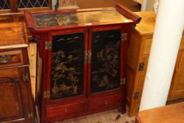 Oriental lacquered cabinet having two lacquered panel doors above two drawers, 93cm by 81.