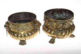 Pair of antique brass planters, embossed and having lion mask handles and paw feet, 22cm by 18cm.