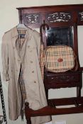 Burberry trench jacket, satchel bag and umbrella.