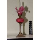 Victorian brass and ruby glass oil lamp, 41cm to top of shade.