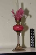 Victorian brass and ruby glass oil lamp, 41cm to top of shade.