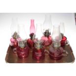 Six Victorian ruby glass finger oil lamps with chimneys and small ruby glass oil lamp (7).