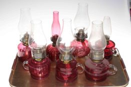 Six Victorian ruby glass finger oil lamps with chimneys and small ruby glass oil lamp (7).