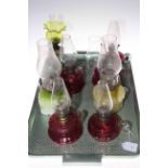 Eight Victorian finger oil lamps including ruby and vaseline glass.