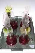 Eight Victorian finger oil lamps including ruby and vaseline glass.