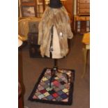 Vintage dress maker's dummy, fur coat, bowler hat, clippy rug, quilt and bed covers.