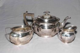 Victorian silver three piece tea set of oval shaped part fluted form, Sheffield 1896.