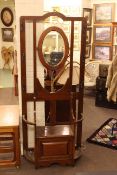 Early 20th Century oak oval mirror backed hallstand, 189cm.