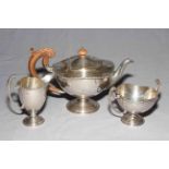 Elegant silver three piece tea set of pedestal form, teapot Birmingham 1911, sugar and cream 1915.