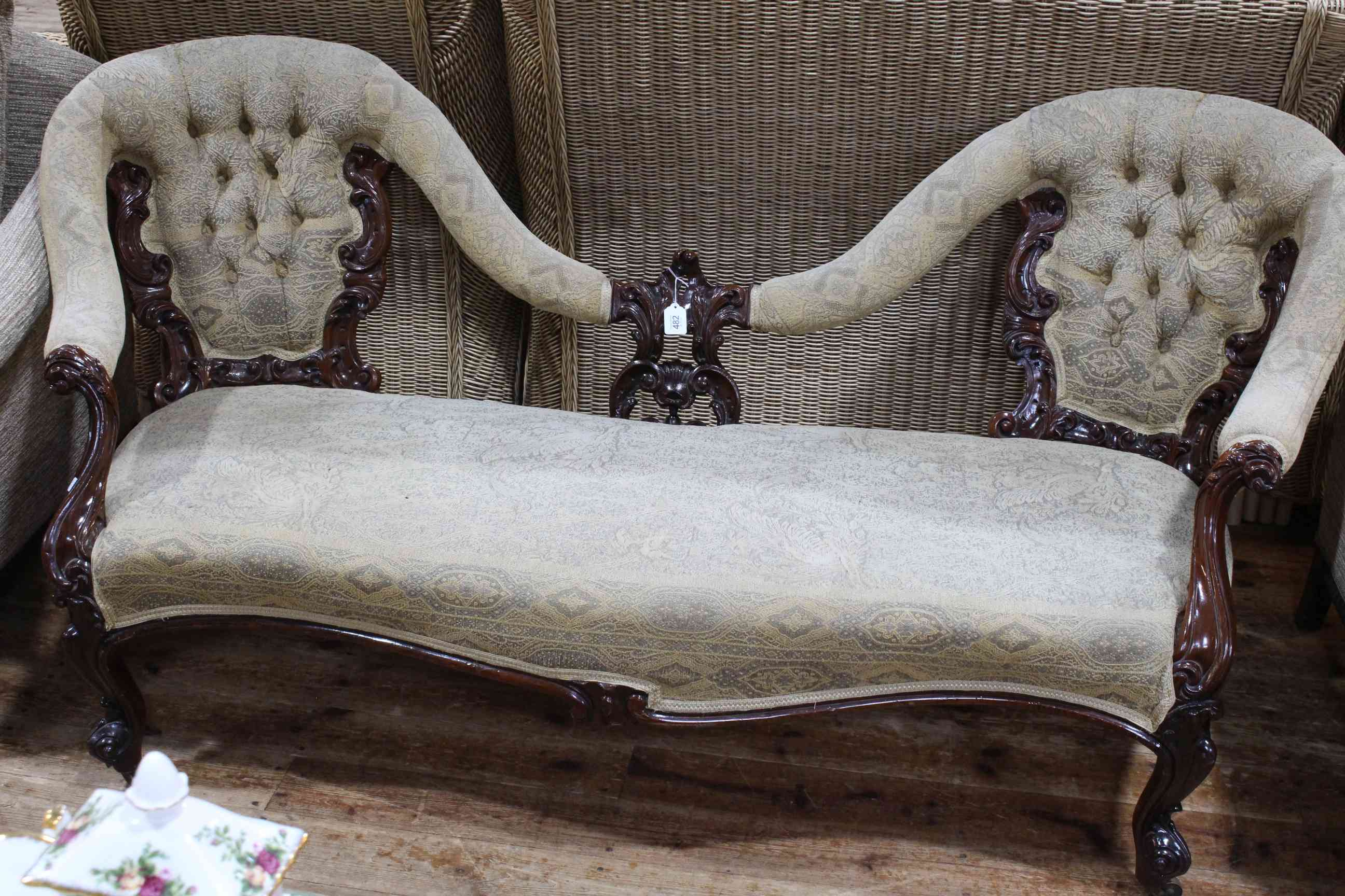 Victorian mahogany double button backed settee with serpentine front seat.