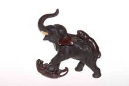 Japanese Meiji period bronze sculpture of elephant under attack from two tigers, 19cm high.