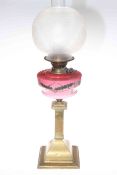 Victorian brass oil lamp with pink decorated glass reservoir and etched frosted glass shade.