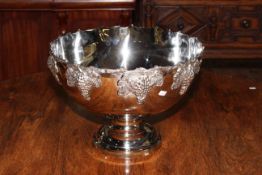 Large silvered metal pedestal punch bowl decorate with grape and vine, 27cm high by 38cm deep.